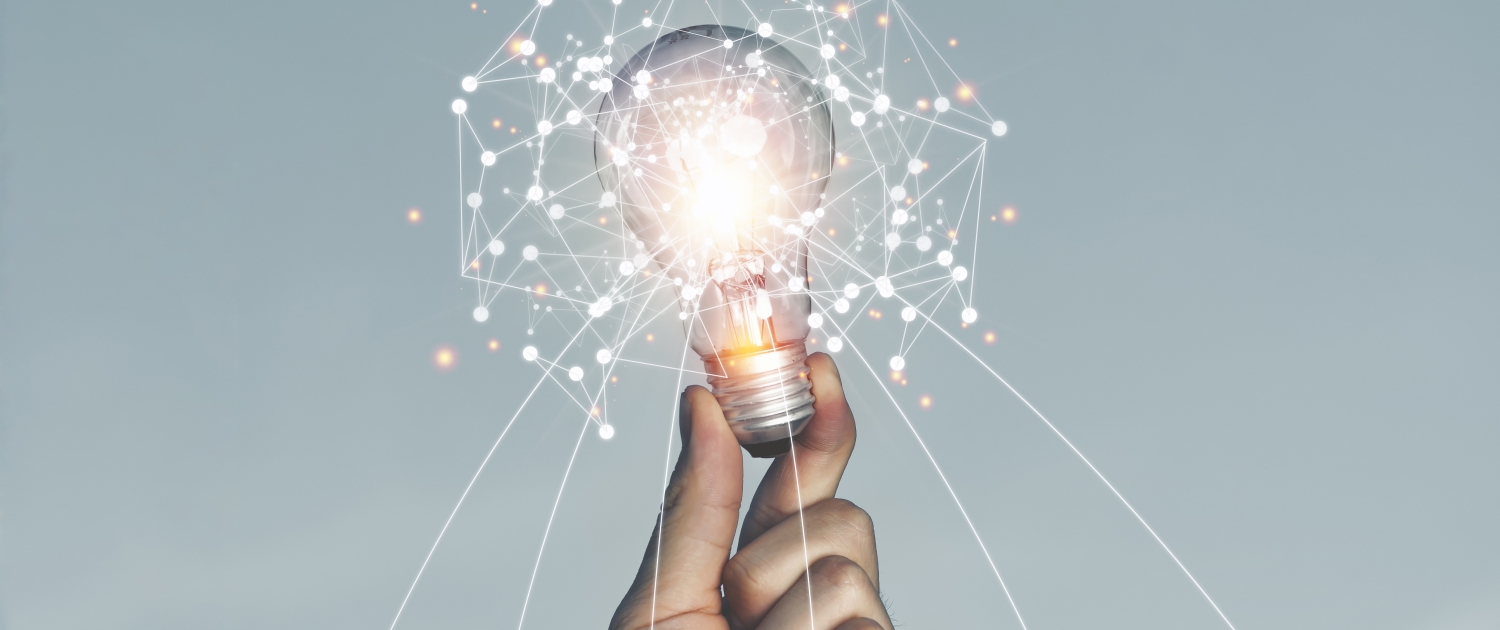A hand holding a light bulb Lifted up in the sky outdoors With new ideas