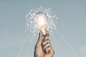 A hand holding a light bulb Lifted up in the sky outdoors With new ideas