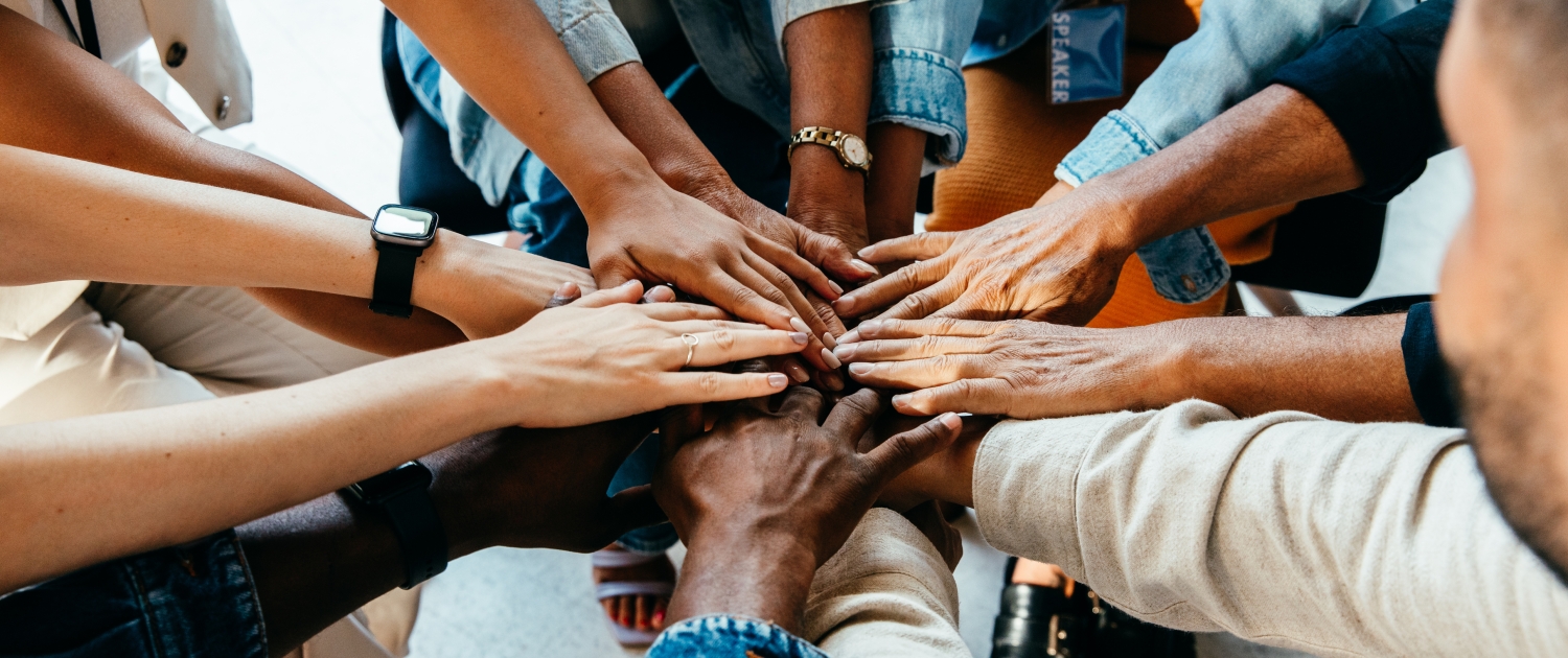 Teamwork concept with diverse hands joining together, symbolizing unity, cooperation, and collaboration