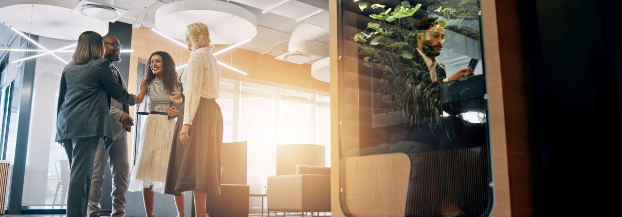 Lobby, corporate and business people with cubicle in office for coworking space for collaboration, teamwork and meeting. Professional, discussion and men and women in workspace pods for productivity