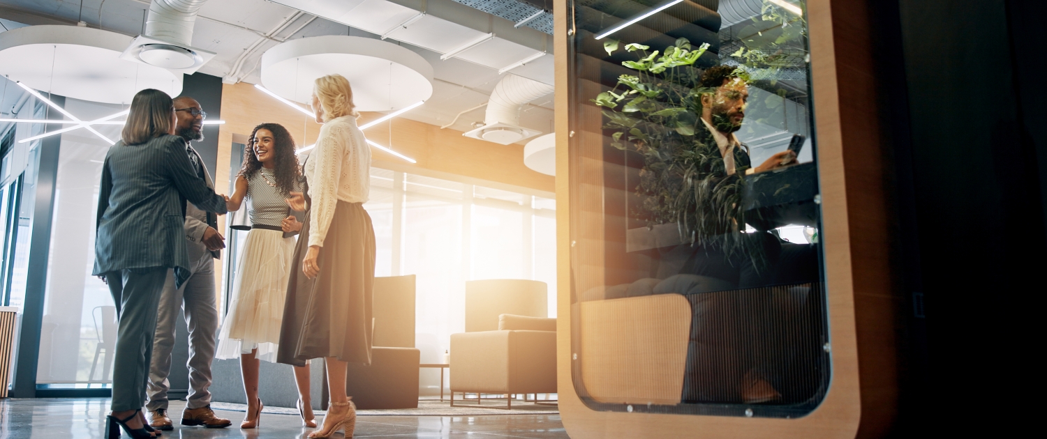 Lobby, corporate and business people with cubicle in office for coworking space for collaboration, teamwork and meeting. Professional, discussion and men and women in workspace pods for productivity